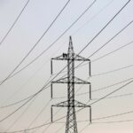 Technicians work to clean power transmission tower in Karachi